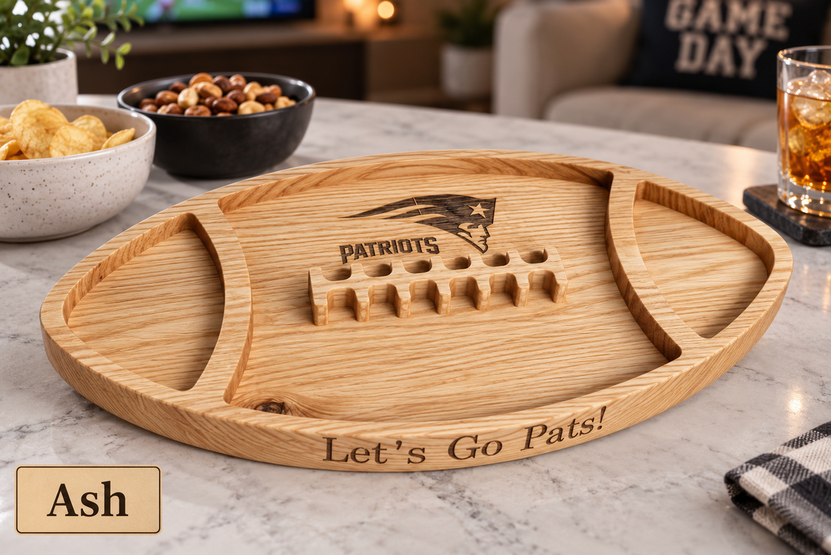 A football-shaped wooden serving tray in a light ash finish, engraved with the New England Patriots logo and &