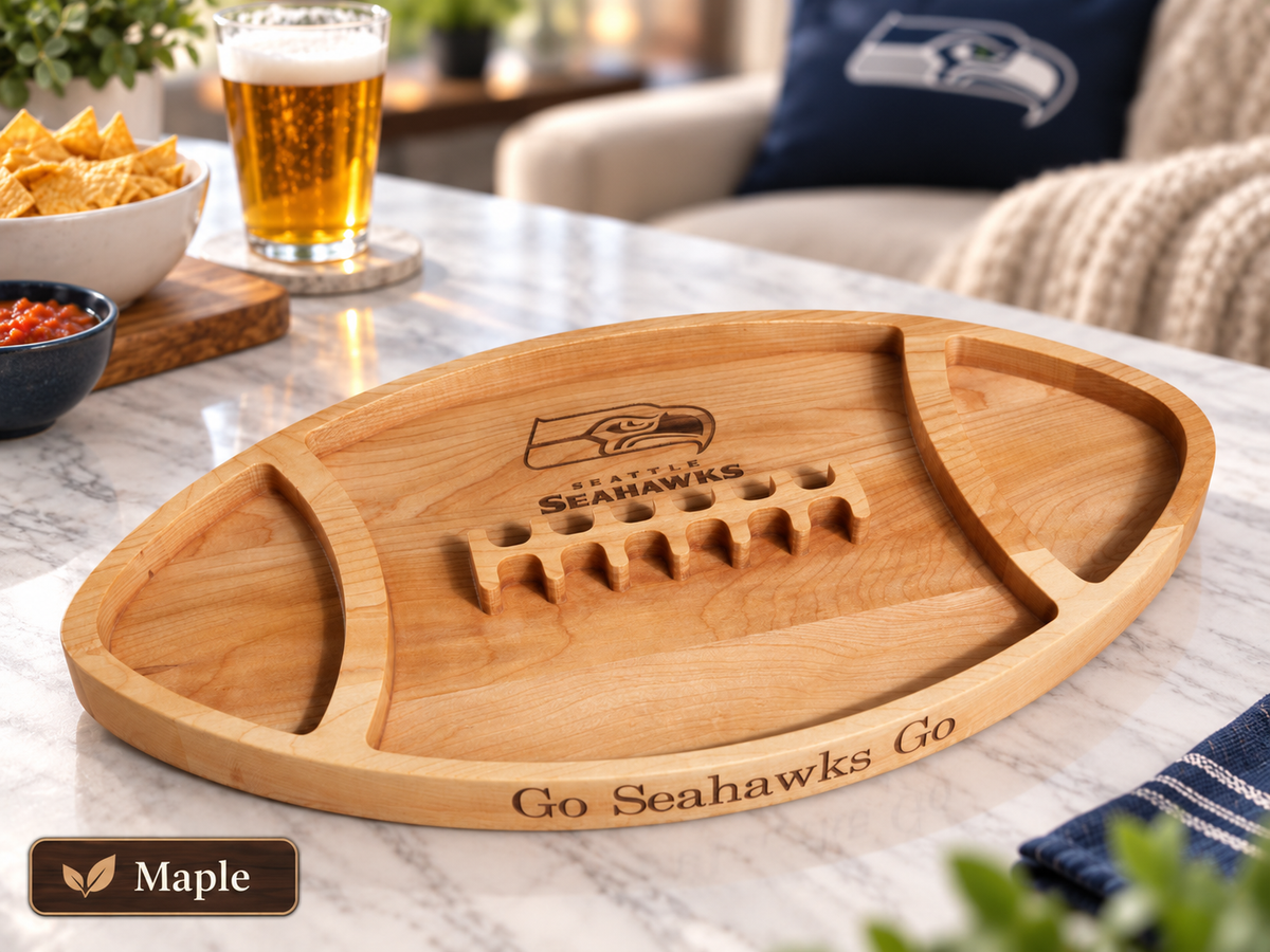 A maple wood football-shaped serving tray engraved with the Seattle Seahawks logo and &