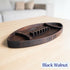 A black walnut football-shaped wooden tray with a small raised center section and engraved text reading '40 BILLS' on the side, shown on a light wood tabletop with a blurred living room background. A label in the corner reads 'Black Walnut'.
